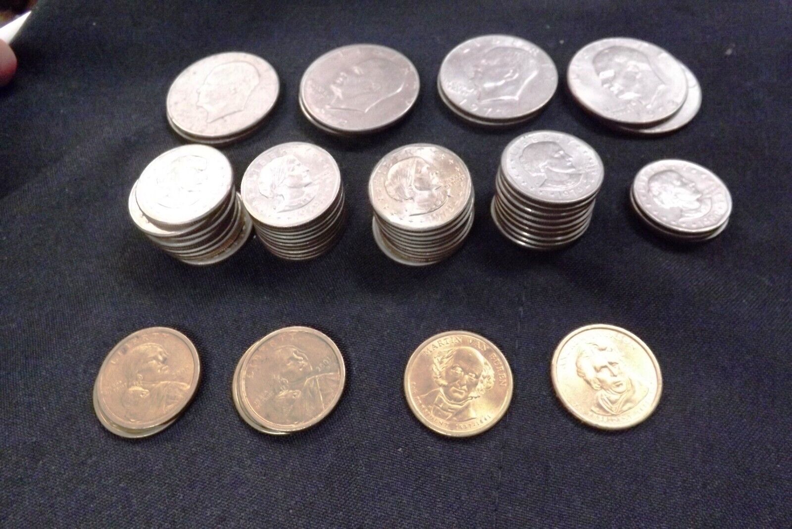 Collection of 57 US Clad Dollar Coins: Ikes, Anthonys, Sacagawea & 2 Pres